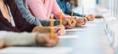 people in a table taking the english test